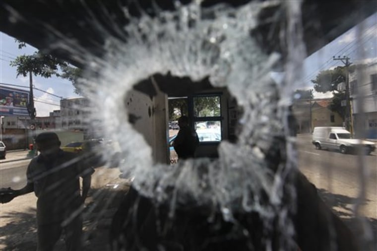 A bullet hole pierces the window of a small police station in the Del Castilho neighborhood in Rio de Janeiro, Brazil, on Tuesday.